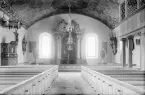 Interiör av Vist kyrka som den tog sig ut före den förödande branden 1961. Vy mot kyrkans kor 1928.