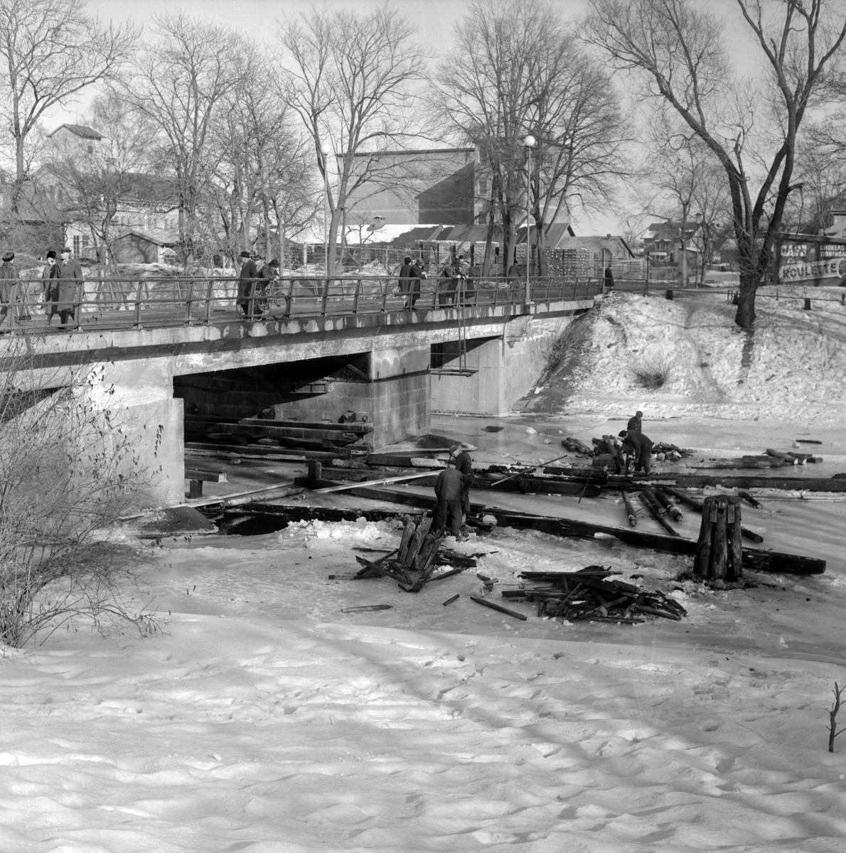 Under 1962 låstes det farbara läget för båttrafiken förbi Stångebro. Längre nedströms hade Tullbron tillkommit som vid sidan av andra överfarter stipulerade endast styvt 3 meters segelhöjd, varför Stångebro inte längre behövde vara öppningsbar. På bilden rivs farledens nu umbärliga konstruktion (dykdalber och följare). I bildens bakgrund bryggde Centralbryggeriet ännu brygd.