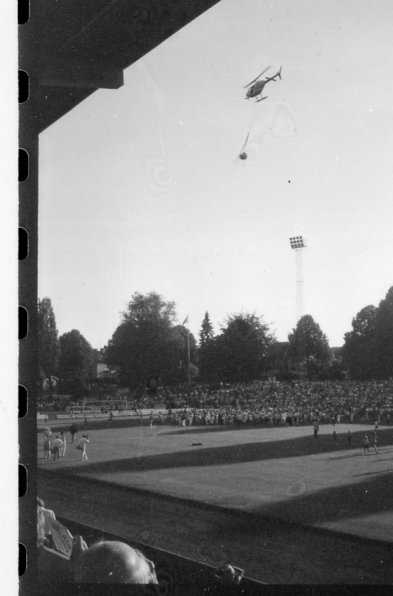 Halmstad, Örjans vall. Prestigederbyt "bäst i stan"- HBK mot Halmia, 18 juli 1984. Foto 1 och 2 (14A-15A) Arla bjöd på gräddtårta. Foto 3, 4 och 5 (16A-18A) Helikopter släppte ner bollar till barnen. Foto 6, 7, 8, 9, 10 (19A-23A) Helikopter släppte ner bollar till barnen. Foto 11 och 12 (24A-25A) Helikopter släppte bollar till barnen. Foto 13, 14 och 15 (26A-28A) Arla luftballong. Foto 16 och 17 (30A-31A) Arla Jet delade ut plastpåsar med reklam.