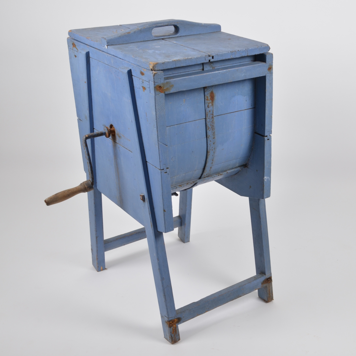 Vaskemaskin for tøyvask. Manuell med håndsveiv. Består av 2 deler, trommel og lokk. Laget av tre, malt blå.