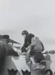 En militär flygspanare kliver i flygplan S 6 Fokker. Flygtekniker assisterar. I förgrunden monteras en handkamera. Omkring 1934.

Text vid foto: 