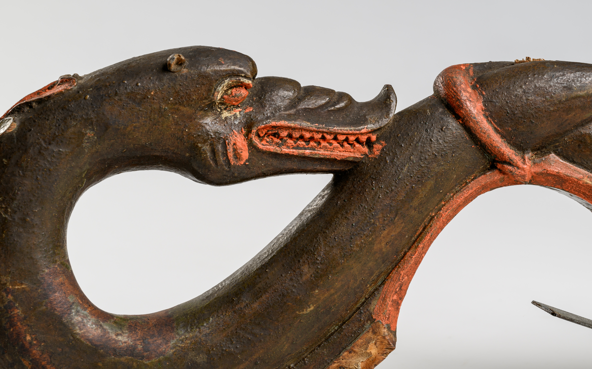 Selbåge av trä. Målad i grön, röd och brun oljefärg.
Skulptural utsmyckning: två drakar.

Inskrivet i huvudkatalog 1886.