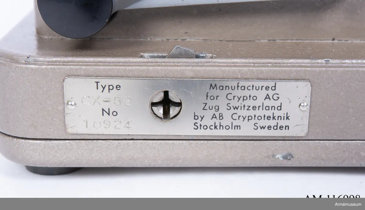 Med nycklar.

Text på liten bricka på högra sidan: "Type CX-52 No 10924, Manufactured for Crypto AG Zug Switzerland by AB Cryptoteknik Stockholm Sweden".

Under krypteringsapparatens lock finns en liten vit lapp märkt "MV Boden Avd 4 Översyn 11 68", dvs troligen Miloverkstaden Boden, november 1968. 

De fysiska nycklarna ger olika access till användarna. Den nyckel med ett hack i ovansidan på nyckeln öppnar endast yttre luckan och dras sedan ut. Därpå förs nyckeln med två hack på nyckelörat in vilket gör att inre luckan går att öppna. Den senare nyckeln ger access till själva innandömet och rotorhjulen går att ta ut efter att sprinten på högra sidan dragits ut.