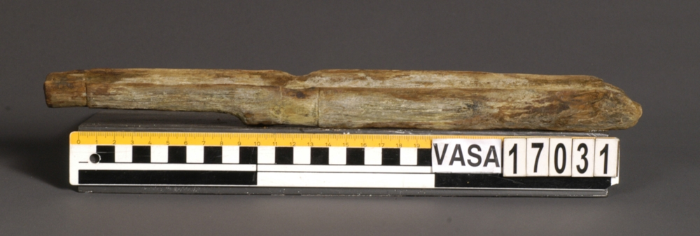 Muskötstock.
Stocken har en öppen ränna för laddstocken.
Den halvcirkulära rännan för pipan är mellan 29 och 37 mm bred. I ganska gott skick, dock med en gulaktig utfällning på ytan.