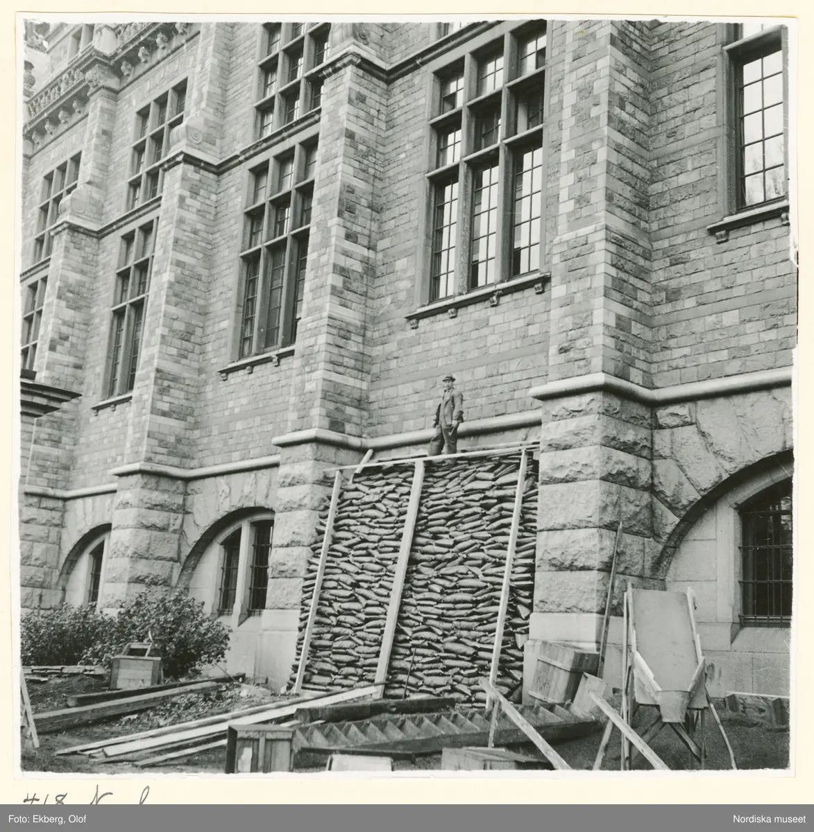 Bild tagen vid Nordiska museets åtgärder inom projektet För luftskyddet under beredskapstiden 1939 till 1940. Byggnaden skyddas med sandsäckar som staplas mot fasaden.