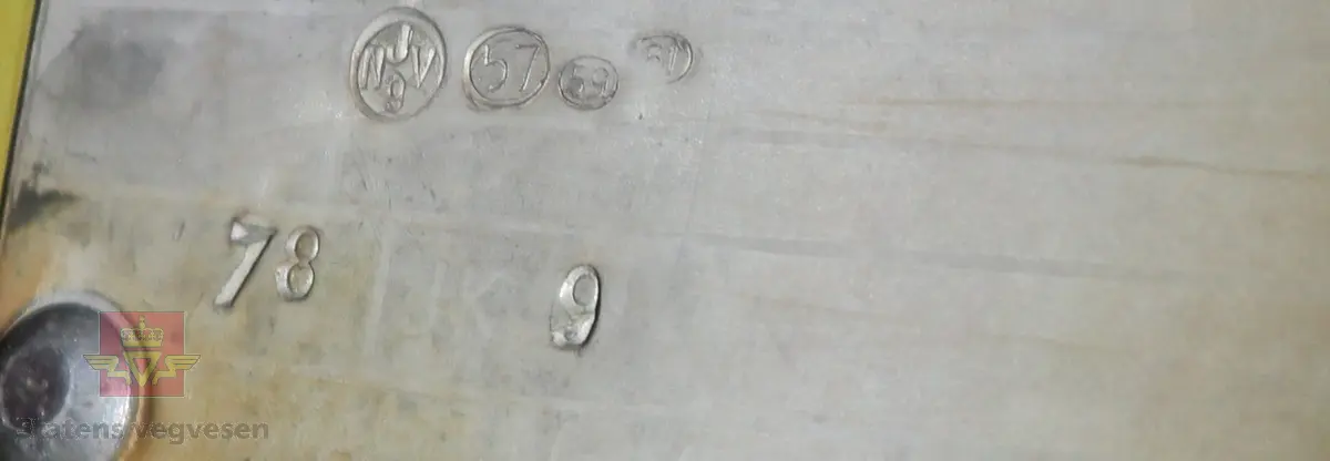 Elektrisk drevet bensinlpumpe med røde sider og gul front. Tekst: SHELL MED ICA. Pumpa har tallskive og viser som går til 100 liter. Kuppel mangler