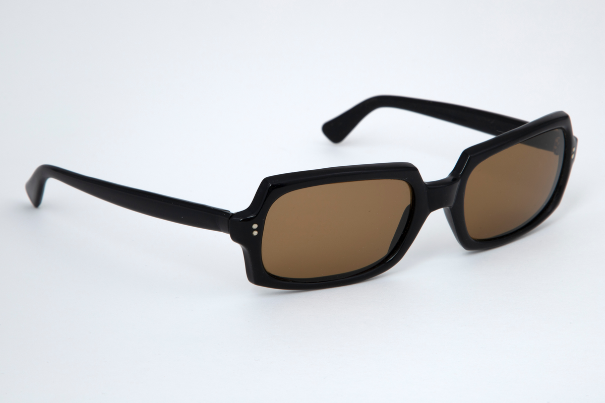 Solbriller med oval kantete plastglass og svart plastinnfatning med hengslede, svarte stenger.