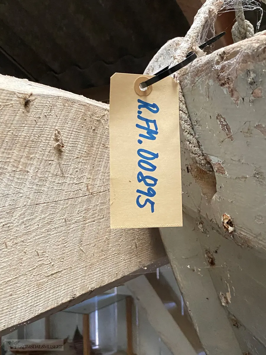 Flatbunnet trebåt med to tofter og ett årepar.