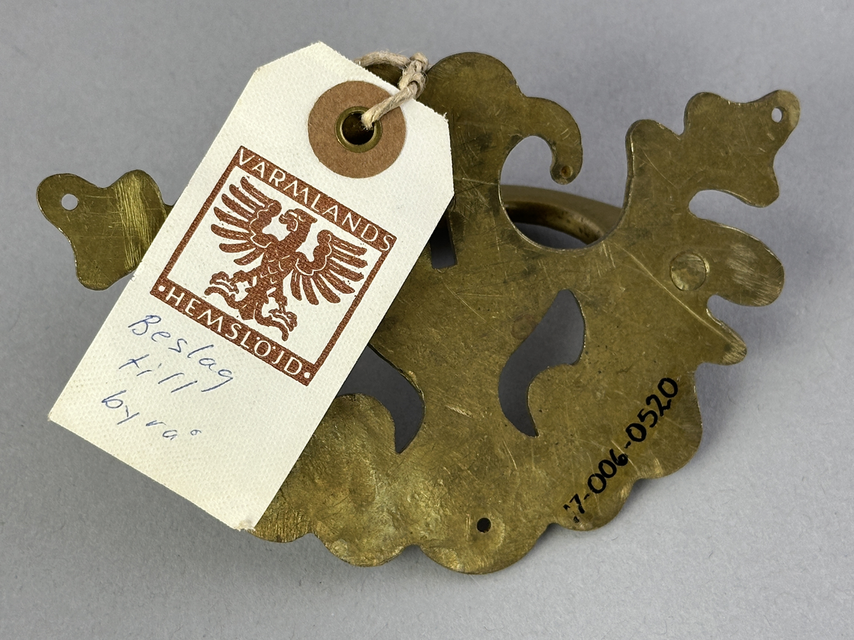 Nyckelhålsbeslag med handtag av mässing till byrå.