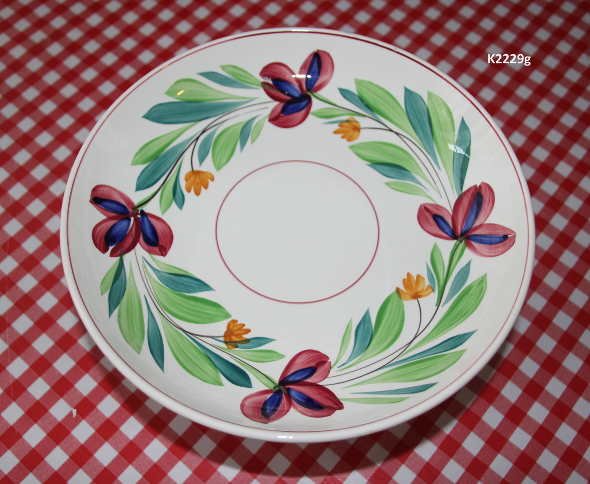 K 2229 
Servise, “Bondemønster”, Saarreguemines, 1900-åreme 
a) Terrin med lokk. 
Lokk. Hvelvet, bred bord langs kanten: grønn gren med røde og blå blomster, rund hankering med røde blad. 
b) Ovalt fat, med bord i brede strøk over bremmen. 
Stemplet i sort: Opaque de Saaregemines, H 169 A. 
c) Ovalt fat. Stemplet fabrikk merke og H 169 W. 
d) Ovalt fat. Stemplet i sort og i godset: 5 K. 
e) Båtformet skål (til pålegg). Avlang rned svakt svungne sider og konkavt buet i kortsidene. 
f) Make til e. 
g) Stettefat. 
h) Kopp. Vid rundsidet kopp, uten stett, forholdsvis lav. Stemplet i sort. 
i) Skål til koppen h).  Stemplet i sort. 
j) Kaffekanne, Pæreformet korpus, bølgende toppkontur, lang tut. Stemplet i sort og 169. Hvelvet lokk med rød toppfarge på lokkgrepet.
k) Fløtemugge, skrånende sider, riller oppe og nede , rillet hank, annerledes enn på den C-formede på kannen.
l) Sukkerkopp med lokk. Skrånende vegger, bredest nede, to hanker, riller oppe og nede, avtrappet lokk. Høyde med lokk 12,5. H. uten 7,2. Diam. bunn 10,8. 
m) Sausekopp. Eggformet skål med en skjellform i relieff , markert med rød farge, i den ene kortside, hvor hanken er. Smal liten skål med bred tut.
Fløtekopp og sukkerkopp av en annen design enn kanne, terrin og sausenebb, men samme mønster. Mønstret er det som kalles “Boerenbont” (broget bondemønster) og som ble laget først i Maastricht 
i Nederland, siden tatt opp av fabrikken Saarreguemirnes i Lorraine,og av Egersund Fayencefabrik i 1930-årene. 
n) Båtformet skål. Som e) Stemplet med sort. 
o) Ovalt fat. Stemplet Sarreguemines med sort og B 169. 
p) Terrin med lokk, stemplet med sort, og L i blindstempel.
Skrå fot, sterkt utskrånende sider, rundet av øverst, to sidehanker.
q) Underfat til terrin, rundt med to hanker. St. med sort og blindstempel: 3 R.
r) Potetfat. St. med sort og sort K.