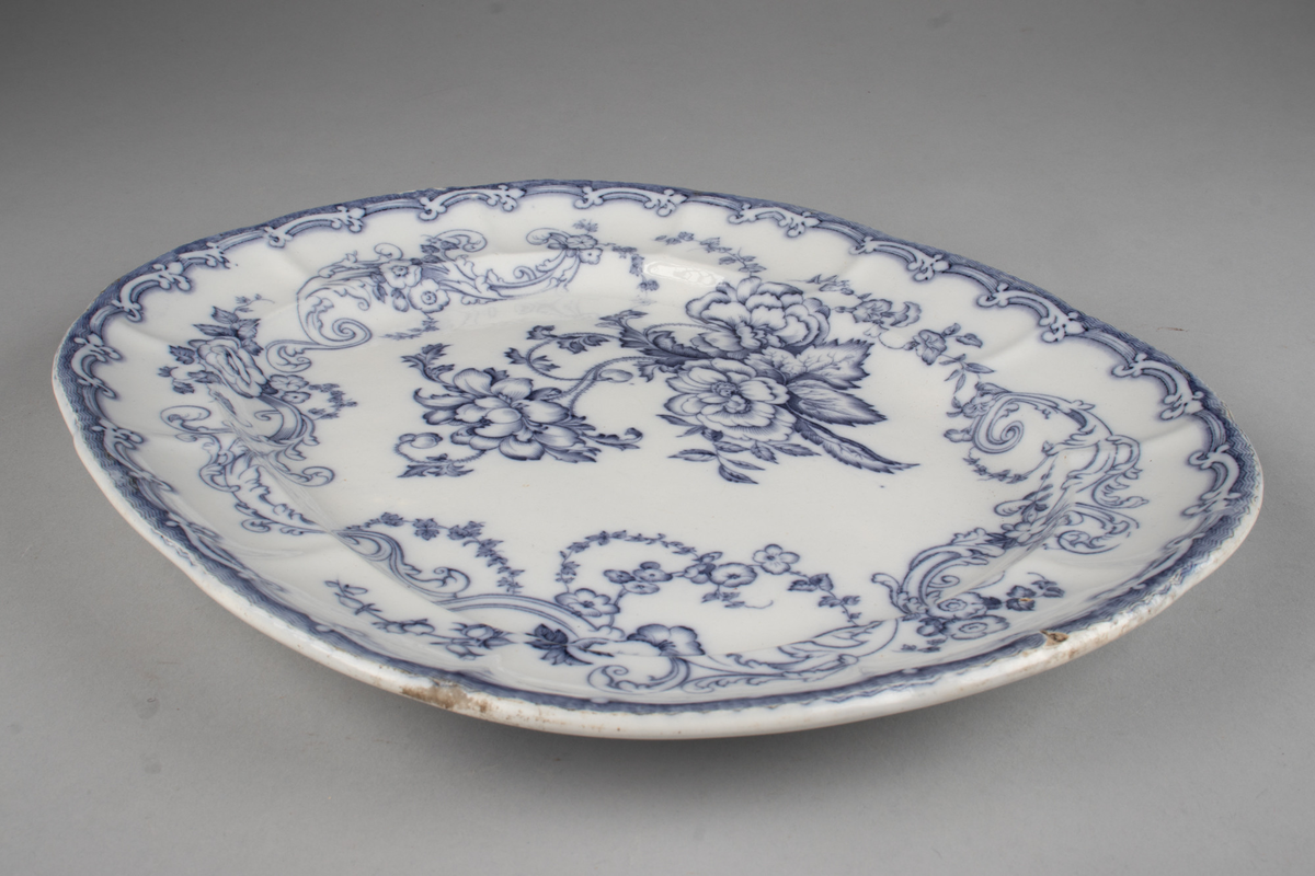 Stort, ovalt serveringsfat i hvitt porselen med blå dekor