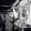 Isbrytaren SANKT ERIK. Maskinist K E Andersson vid telefonen i aktra maskinrummet.