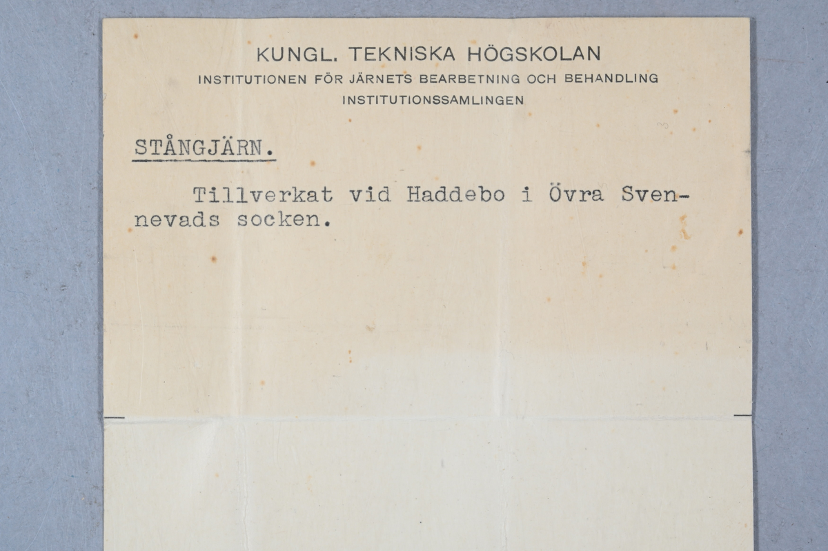 Prov av stångjärn. Provet märkt med Haddebo bruks stämpel. Tillhörande lapp med notering: "Stångjärn. Tillverkat vid Haddebo i Övra Svennevads socken."