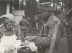 Stockholms Landstormskvinnor övar på Järvafältet. Försäljning av varmkorv med bröd. Foto av löjtnant Kronberg, cirka 1930.