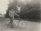 Sjukvårdare med cykel vid landsväg. Uniform m/1910.