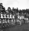 Gymnastikuppvisningen, 25/5 1941. 
Kvinnliga gymnaster har uppvisning på bommar, med viss assistans av
några manliga gymnaster.
