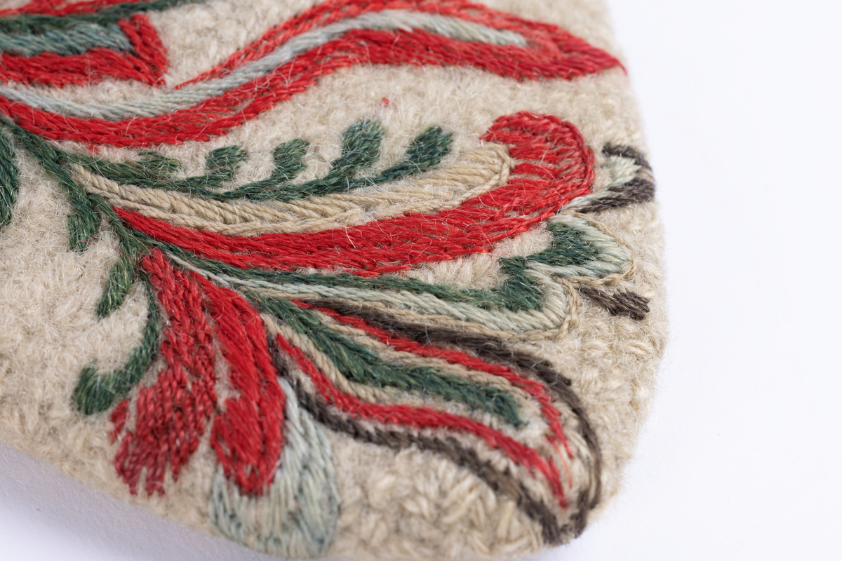 Hvite votter i nålebinding med dekor ab broderi og applikasjon.