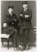 Två unga män hos fotografen, i kostym och skärmmössa med emblem.
Ernst Bjersing (senare kronolänsman och landsfiskal) till höger, under studietiden.
Helfigur, ateljéfoto.