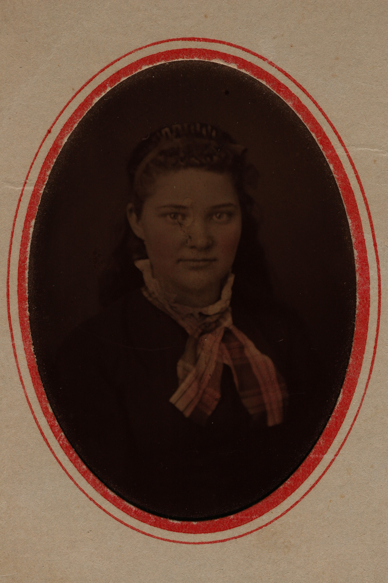 Portrett av en ung kvinne med rutete halstørkle. Hårbånd i utslått hår.