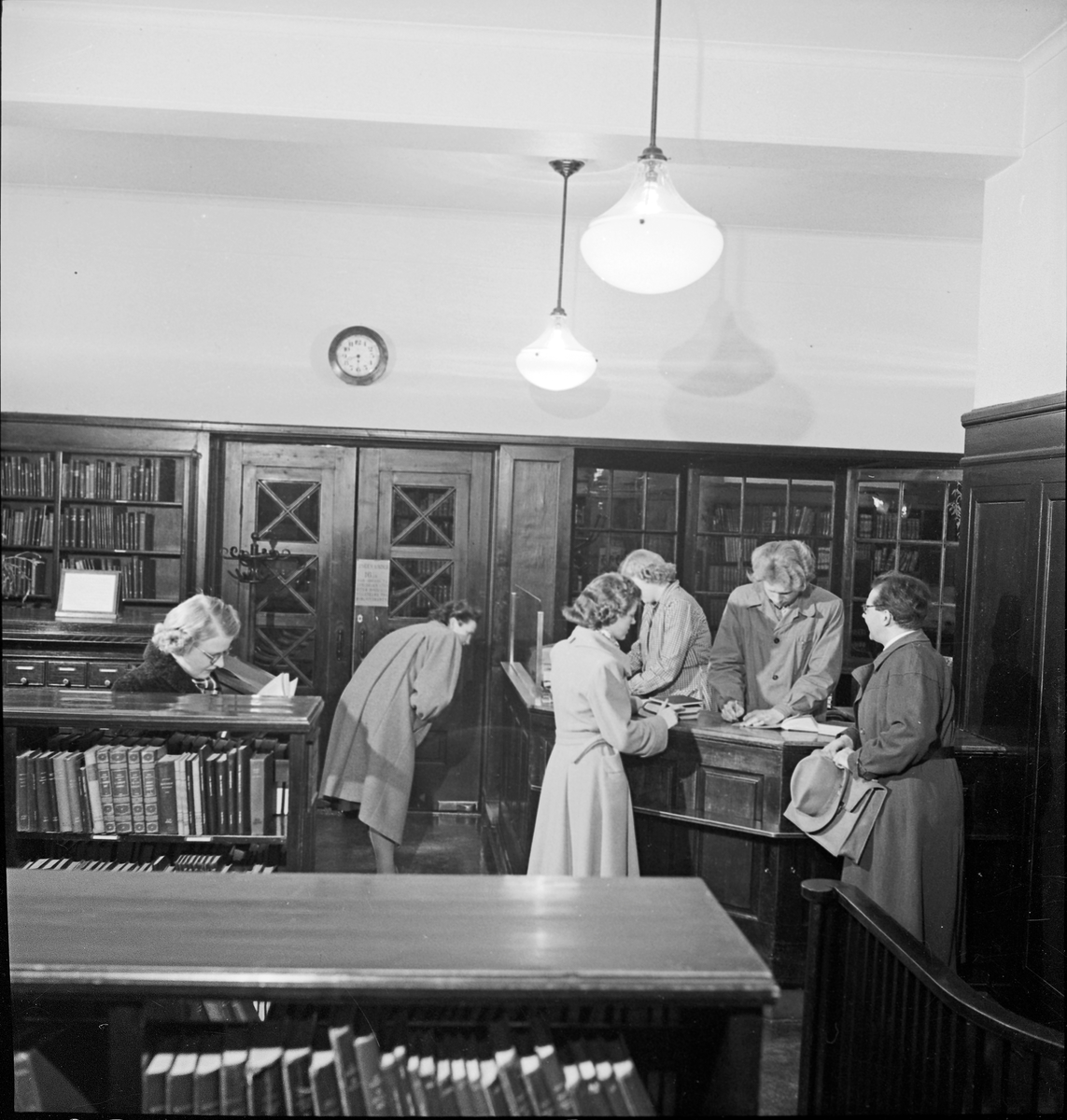 Personalet på Rjukan bibliotek stående ved skranken i biblioteket.