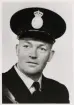 Poliskonstapel David Sandström, Åseda, i full uniform, ca 1955-60. 
Bröstbild, halvprofil. Ateljéfoto.