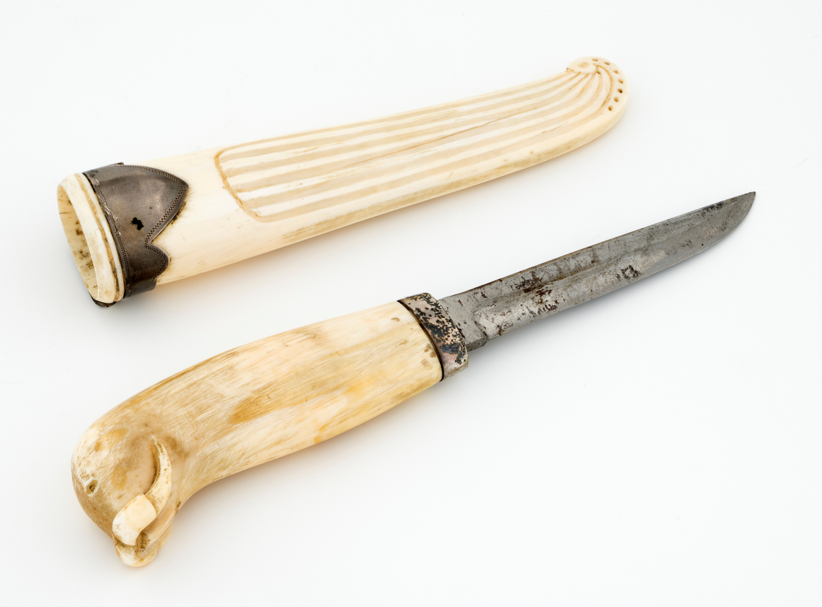 Tollekniv som har tilhørt offiseren og polfareren Hjalmar Johansen (1867-1913), som var kjent fra Fridtjof Nansens Fram-ekspedisjon (1893–1896) og Roald Amundsens Sørpolekspedisjon (1910–1912). Kniven har blad som antas å være av jern og stål, mens skaftet og slira skal være utført i hvaltann, for sliras del suplert med en skaftholk av sølv. Skaftet og slira er åpenbart håndlagde, men vi kjenner foreløpig ikke knivmakerens indentitet.

Kniven er 18,9 centimeter lang. Bladet utgjør 9,2 centimeter av dette lengdemålet. Det er 1,5 centimeter bredt bakerst ved brystningen. Her er tjukkelsen 3,2 millimeter, men bladet tynnes gradvis mot spissen, hvor det er 2,1 millimeter tjukt. Den bakre delen av bladryggen er rettlinjet, men de fire fremste centimeterne skrår svakt ned mot bladspissen. Kantene på bladryggen er noe avfasete. Slipefasene på eggsida er opptil 8 millimeter brede. Bladet har ingen stempler eller andre signaturer som tydeliggjør produsentens identitet, men mye tyder vel på at dette er et «fabrikkblad» - altså en masseprodusert komponent.

Tangen i den bakre enden av skaftet er tappet inn i et 9,7 centimeter langt skaft, lagd av gråkvit hvaltann. Den fremre skaftenden er forsterket med en 7,3 millimeter bred skaftholk med glatt overflate. Skaftet er konvekst i formen, og det har, som på knivskaft flest, et ovalt tverrsnitt. Den bakre skaftenden er en aning krum - mot buksida. Denne delen av skaftet er formet som hodet på en hvalross (Odobenus rosmarus), en selart med store, buete hjørnetenner. Denne arten er utbredt i grunne kystområder i det arktiske nord, altså i miljøer eieren av denne kniven besøkte på ekspedisjoner han var med på.

Slira er et 14,8 centimeter langt hylster, tilsynelatende lagd i ett stykke av hvaltann. Den er noe asymmetrisk i lengderetningen. Her er det med andre ord lett å se i hvilke reninger bladryggen og egglinja skal ligge når kniven stikkes i slira. Baksida av slira har glatt overflate. På forsida er det skåret et riflemønster som ender i et buet endeparti nederst på slira. Her er det ingen metallbeslag, men sliremunningen i overenden er forsterket ved hjelp av en sølvholk med profilert (flikete) nederkant. På baksida av denne komponenten, som er laget av sølv, er det påloddet ei hengsle for en opphengsstropp, som ikke er intakt.