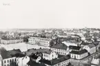 Vy från domkyrkotornet över stortorget, Växjö, med bl a residenset, mot nordväst. I bakgrunden skymtar man fängelset och Kristinebergs bryggeri. Ca 1900.
Vykort efter fotografi.