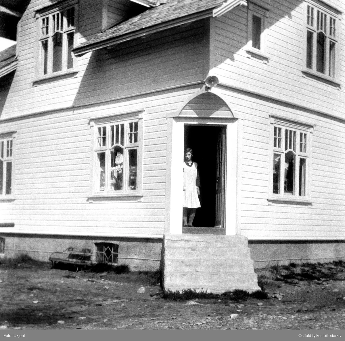 Hjørnerud landhandel i Rokke, Halden, trolig ca. 1930. Eier Ingegjerd Paulsen i døren. Butikken ble antageligvis nedlagt på 1960-tallet.