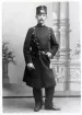 Poliskonstapel Carl Wilhelm Liljegren, Växjö, i full uniform.
Helfigur, en face. Ateljéfoto.