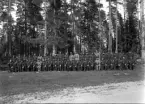Foto av en pluton (?) militärer med befäl.
I 11, Växjö