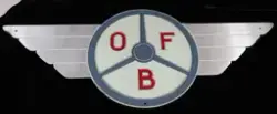 Skilt. Ubrukt, flerfarget skilt av aluminium. Skiltet er formet som en OFB logo og har teksten OFB.