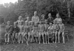 Foto av en grupp pojkar, klädda i badbyxor m.m.
Simskola (?)
