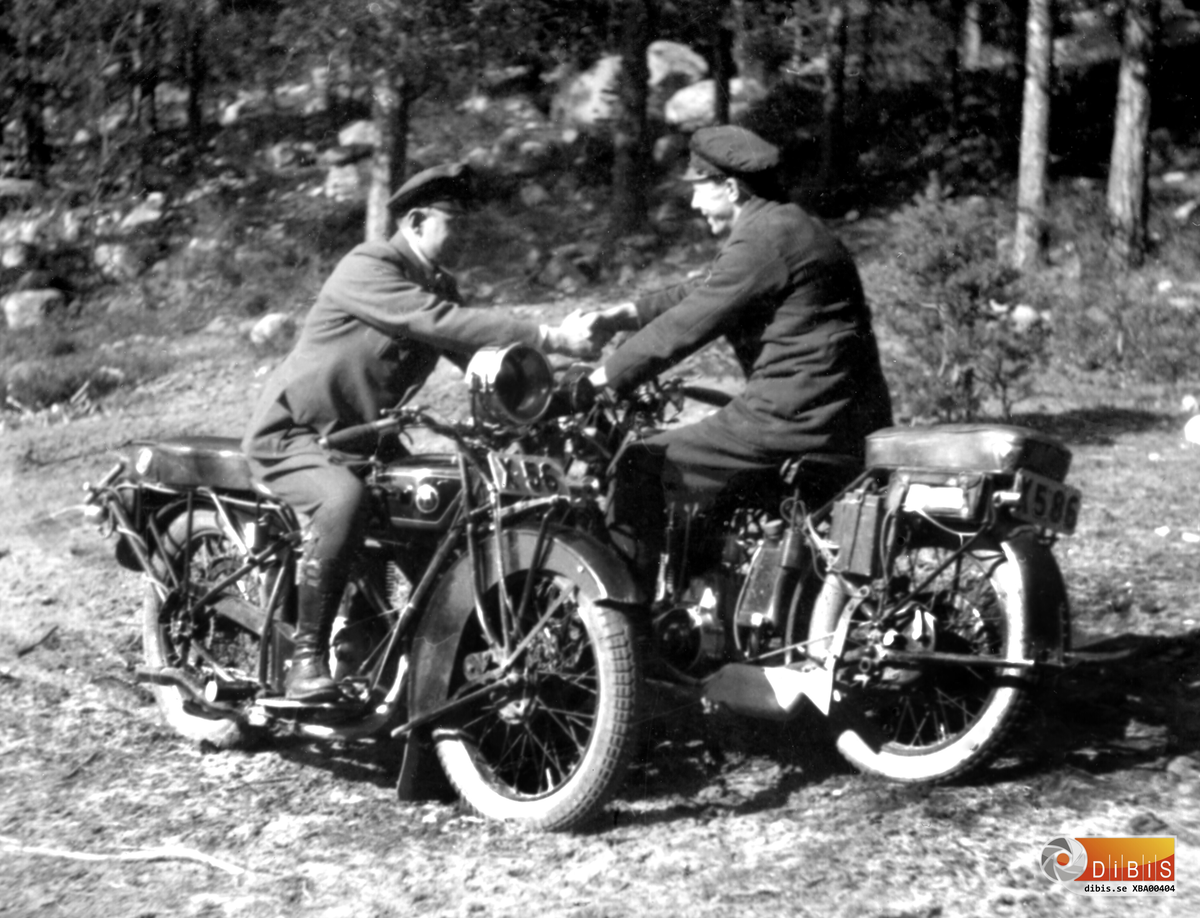 Två motorcyklar modell större och förare som tagit sig ut i terrängen.
