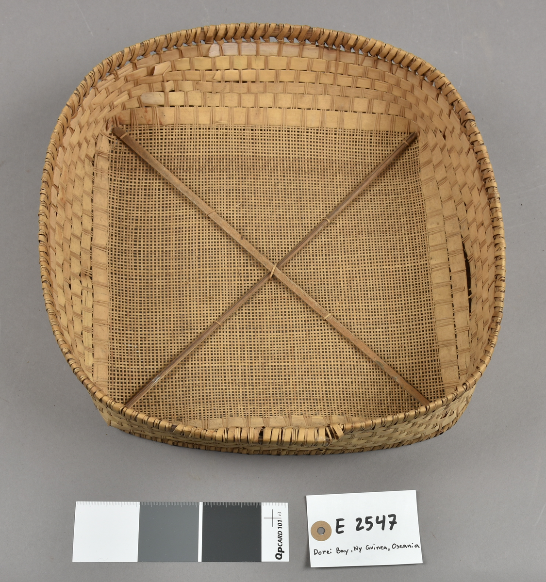 E 2547 Sold til at sikte ris og sago i, dannet som en lav flettet kurv, bunnen er et fint nett av smale bambus-spiler. 29 cm. i tverrmål.#Amboina, Dorei Bay, Ny Guinea, Oseania