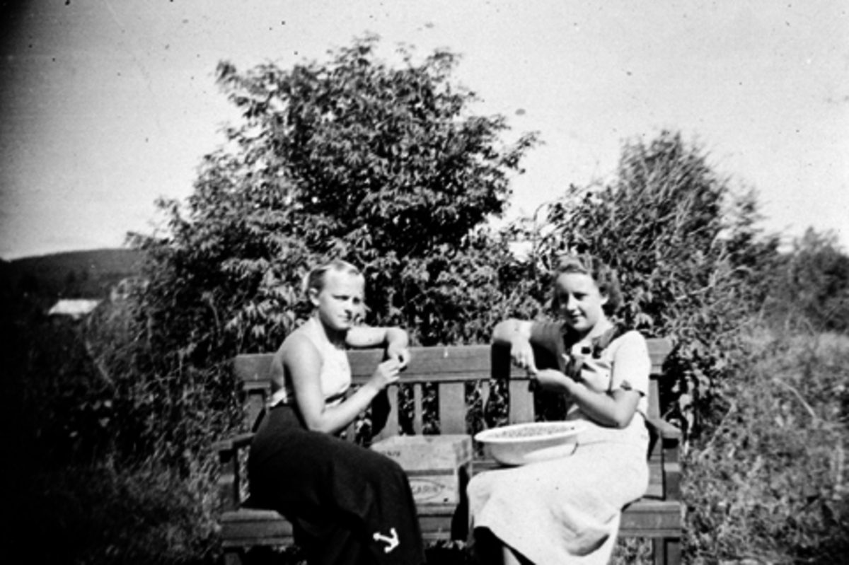 HEDMARKSMUSEET, DOMKIRKEODDEN. T. V KARIN TANGEN, F. SANDEN OG RANDI HANSEN F. MOEN, RENSER STIKKELSBÆR, SITTER PÅ EN BENK UTENFOR DEN GAMLE VAKTMESTERBOLIGEN, HAUGEN. , CA 1939-1940
