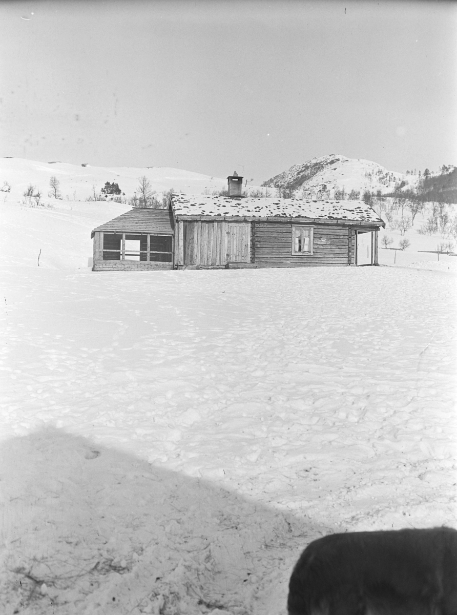 Vinterbilde fra Songli gård. Tømmerbygning med et moderne påbygg.