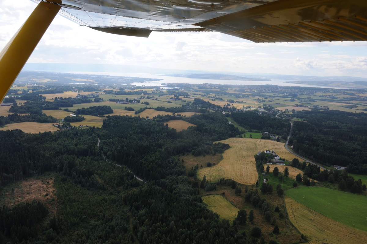 Flyfoto. 
Luftfoto utført i forbindelse med Vangsboka. Gårder i Vang, samt noe Hamar by fra lufta. 