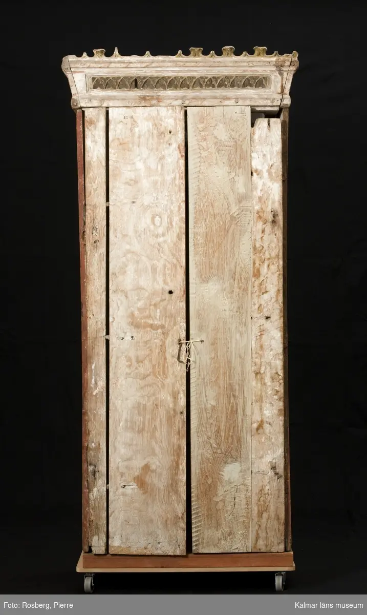 KLM 8048. Altarskåp, madonnaskåp. Av ek med sittande Madonna. Baldakin med masverk och ett krönande överstycke med masverk, krönet är snedställt. Baldakinens masverk döljs när dörrarna är stängda. Baldakinen bärs upp av två kolonner. Skåpet har dubbla vikbara dörrar. Det vänstra dörrparet består av fyra plankor, sinsemellan sammansatta två och två med dymlingar i fogarna. Det högra dörrparet består av i den inre dörren endast av en planka, den yttre har en ny planka limmad till den äldre delen. Skåpets bakstycke är sammansatt av två plankor. Skåpets plankor är varierande i bredd. Bottenplatta och sockel för stolen är nytillverkade. Barnet och Marias högra arm saknas, liksom kronans blad och några av krönets taggar. Dörrarnas insidor med målad bladornamentik, akantusornamentik, i rött, svart, grått, vitt. Marias kjortels nuvarande bemålning är rödbrun, under denna syns den ursprungliga kraftigt röda färgen, man kan även ana schablonmönster, den ursprungliga färgen är bevarad i stor omfattning. Rester av blått i foder. Mantelns nuvarande bemålning är ljust blå. Datering: 1400-tal. Nuvarande bemålning 1600-tal eller tidigt 1700-tal.