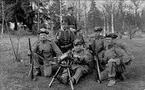 Gruppfoto, militärer i Landstormsuniformer och med vapen.