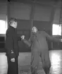 Förevisning av kampsport på F 2 Roslagens flygflottilj, 1940. Flygvapenungdom förevisar vridning av hand och arm, inomhus.