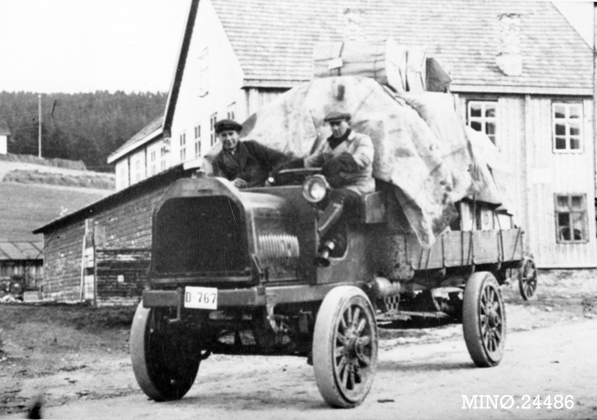 Menn på åpen, gammel lastebil.