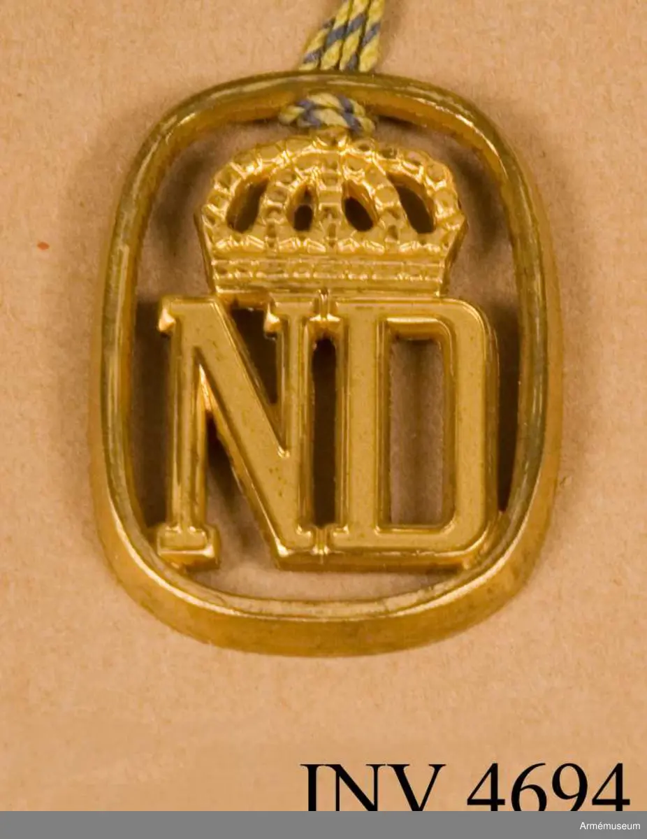 Till uniform m/1960 och m/1968 bär all personal vid förbandet  baskermössa (mörkgrön) och anläggs på denna baskertecken som  utgörs av bokstäverna ND omgivna av en oval (bild 1). Tecknet är tillverkat av metall i guldfärg. Det har tillverkats både med stift för fastsättning och utan. Tidigare hade regementet till m/ä som förbandstecken bokstäverna NDR under kunglig krona, till övriga uniformer förbandssiffra. I generalorder 19570711 nr 1654 fastställdes nytt förbandstecken för  regementet. Det blev en återgång till det gamla tecknet men  medtogs inte bokstaven R enär regementet år 1958 skulle  omorganiseras till bataljon.Ädelsmeden Sigurd persson har vid sin formgivning av tecknet i huvudsak behållit 1957 års modell (bild 2), men något  förändrat bland annat kronan.Vidhängande etikett anger dag för fastställande: 'Stockholms Slott 28/12 1960 Sven Andersson  H. Henning'. < 19601228 >.