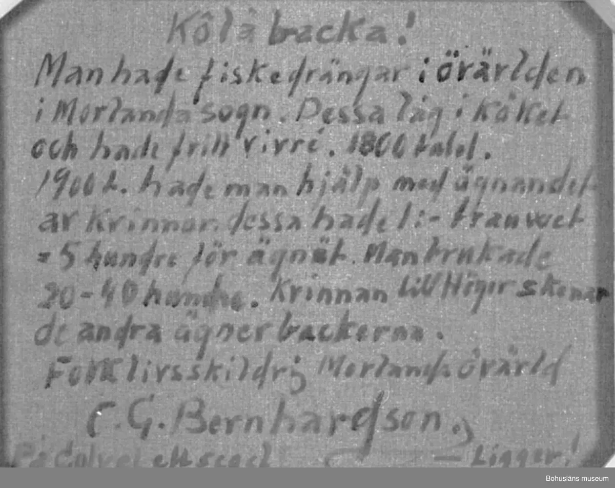 Baksidestext: 
"Kôläbacka!
Man hade fiskedrängar i övärlden i Morlanda sogn. Dessa låg i Köket och hade fritt vivré. 1800 talet. 1900 t. hade man hjälp med ägnandet av Kvinnor. dessa hade 1:- trauwet = 5 hundre för ägnät. Man brukade 20 - 40 hundre. Kvinnan till Höger skenar 
de andra ägnar backerna.
Folklivsskildring Morlanda övärld
C.G. Bernhardson.
På golvet ett segel - Ligger!"

Ordförklaring: Kôläbacka = koljebacka, krokfiskeredskap, ägna, ägnät = agna, agnet (betet), trauwet = tråget, skena = ta ur (blåmussla). Dialektala uttryck. Fritt vivré (vivre) = fritt uppehälle (fr.).

Litt.: Bernhardson, C.G.: Bohuslänsk sed och folktro, Uddevalla, 1982, s.154. 
Titel i boken: "KôLabackeägne.
Under den stora krokfisketiden här i bohuslänska övärlden hade åtskilliga fiskare både fiskardräng och piga. 
Dessa huserade i kök och kammare, allt efter utrymme och förutom liggplats i soffa ingick löneförmånen fri mat och kanske någon styver. 
Fram på 1900-talet var fiskardrängen försvunnen, nu fick backefiskarn hjälp med ägnandet främst av grannkvinnor mot er ersättning av en krona trauwet = fem hundra backer. 
På bilden ser man att kvinnan till höger på bilden "skenar schäl" =  öppnar blåmussor, de övriga i köket ägner backa.
På köksgolvet ligger ett gammalt målat segel som skydd, det rann mycket vatten vid detta arbete från baljor och trauw (tråg).
Tidsbild I tiden."

Övrig historik; se CGB001.