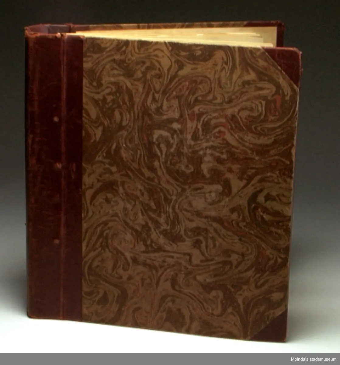 Pärm med titeln "Praktisk vävbok", med exempel på olika vävtekninker, som illustreras med textila vävexempel. Pärmen innehåller också ihopbundna pappersark med titeln "Anteckningar i materiallära", samt emellanåt lösa papperslappar.