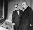 Jubileumshedersgäst var dåvarande kung Gustaf VI Adolf. Här
berättar museichefen Gilbert Svensson för kungen om tryckmaterialet
till skilling banco-frimärkena.