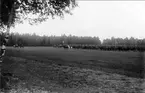 Reg återkomst från höstmanövern 1934. Förbimarsch för general E Testorp. Överste H Peyron förde regementet, standarförare löjtn Melcher Wernstedt, musikkåren under fanj Borgmans ledning, pukslagare furir Wendel, pukhäst Orkidé E Udiacus-Ischtums.