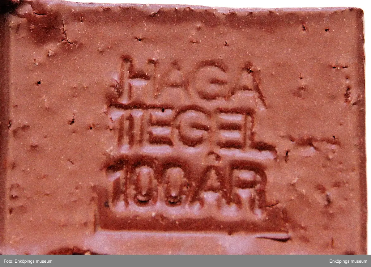 100 års minne av Haga Tegelbruk 1984. Tegelbruket har anor från 1700- talet, men då i privat ägo. Teglet är märkt Haga Tegel 100 år och årtal 1984. Utformning en ett och två nollor.