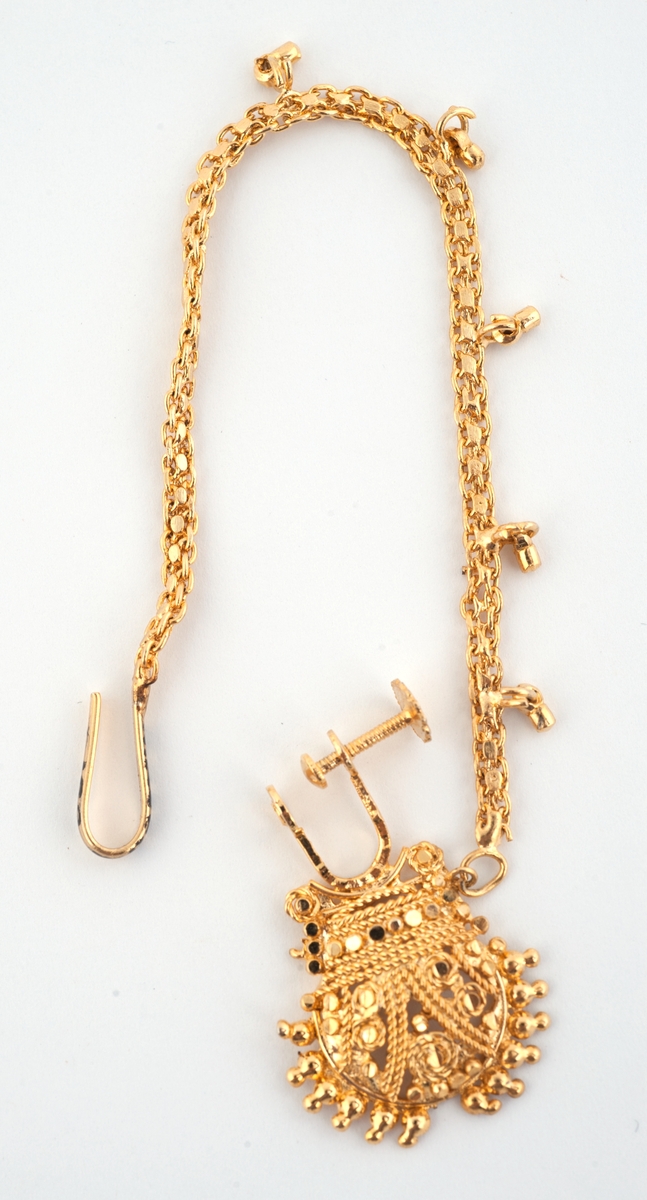 Gullfargede smykker til brudedrakt. Består av 9 armringer, et par øreheng, 2 halssmykker og 2 anheng = ukjent bruk