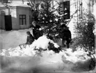 Tre barn med sparkstötting.
Bostadshus.
Sven Elof, Karl-Erik och Ingrid Lindskog