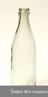 Lemonadflaska av ofärgat glas.Flaskkroppen konande mot halsringen.Svagt inbuktad botten. Flaskan märkt med Å med stjärnor på var sida och ovanför och n underst.